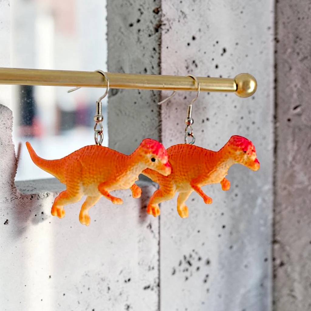 WhatsApp Image 2026-06-04 at 11.56.27 AM (3) aretes locos dinosaurio naranja - Imagen 1