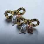 aretes de acero moños tri color