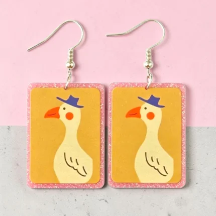 Carrito 33 ARETES DE PATO EN CUADRO ROSA